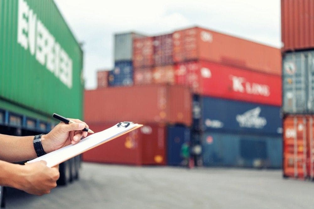 Black African logistics courier managing shipments in a warehouse