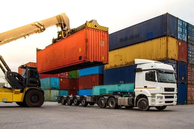 Black African workers beside transport trucks in a logistics operation